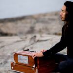 A person playing an instrument on the beach