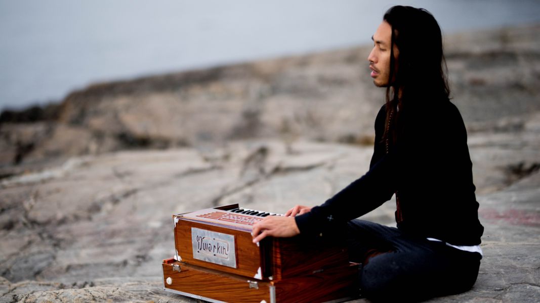 A person playing an instrument on the beach