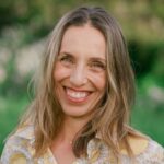 Sarah Seleky smiling in front of a meadow